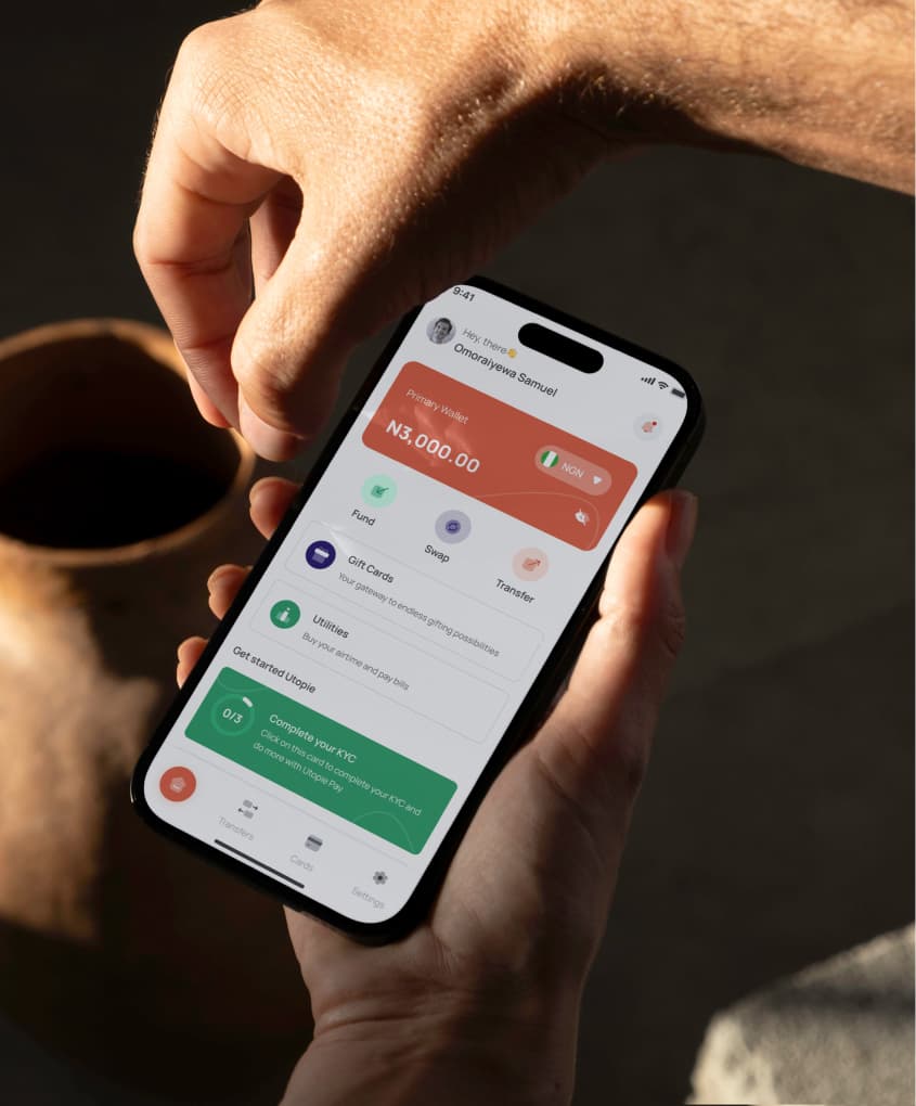 Utopiepay app on a phone held in hands